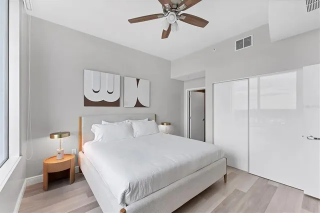 a bedroom with a bed and a chandelier