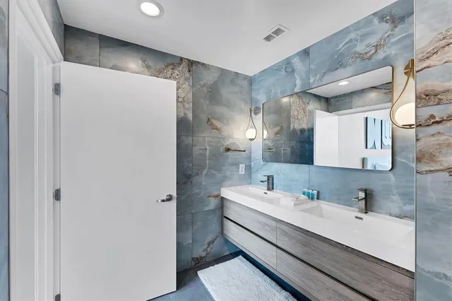 a bathroom with a double vanity sink and mirror