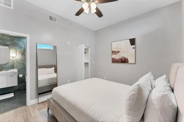 a bedroom with a white bed and white walls