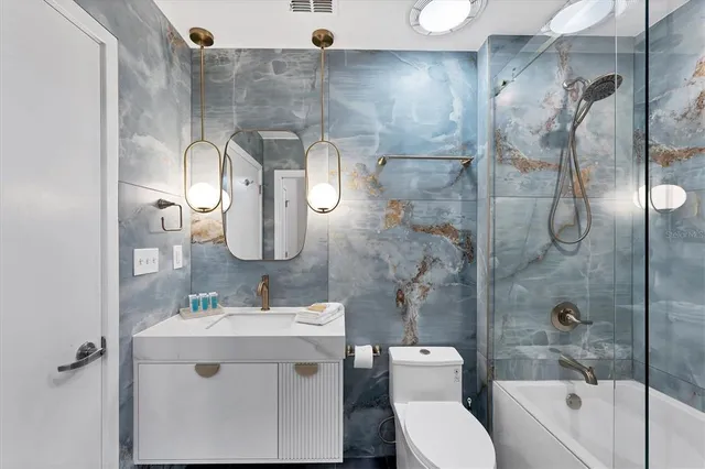 a bathroom with a toilet sink and shower