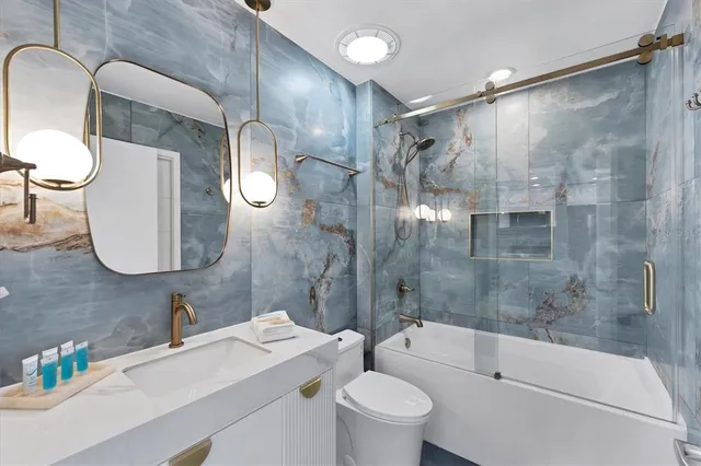 a bathroom with a sink toilet and shower