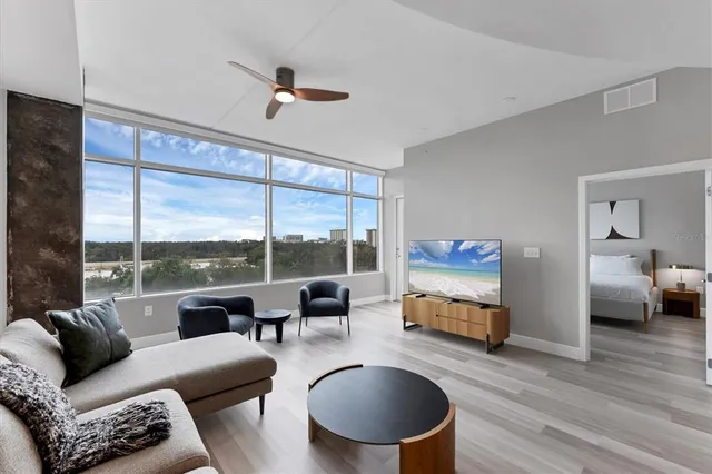 a living room with furniture and a large window