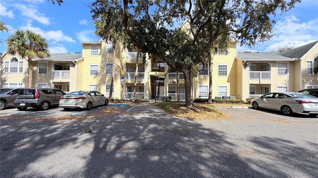 1037 South Hiawassee Road, Unit 2825 Orlando, FL 32835 - Photo 1 of 16 a view of a cars parked in front of a house
