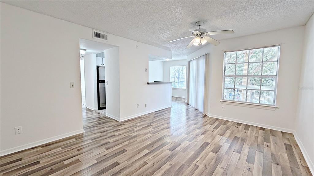 1037 South Hiawassee Road, Unit 2825 Orlando, FL 32835 - Photo 13 of 16 a view of an empty room with wooden floor and a window