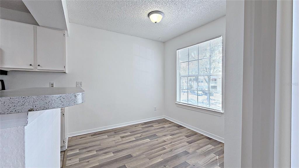1037 South Hiawassee Road, Unit 2825 Orlando, FL 32835 - Photo 14 of 16 an empty room with wooden floor and window