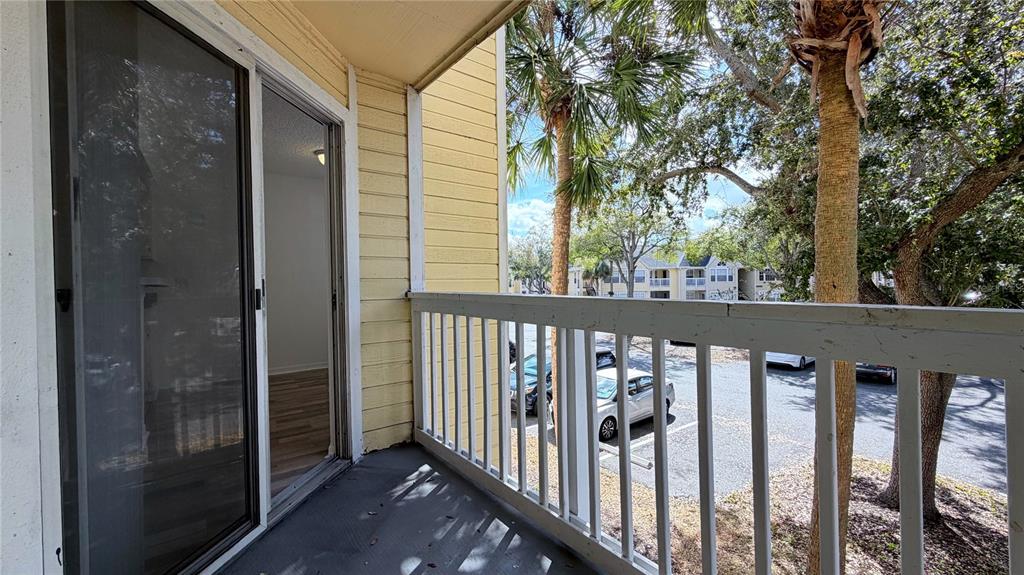 1037 South Hiawassee Road, Unit 2825 Orlando, FL 32835 - Photo 15 of 16 a view of a porch with a small yard