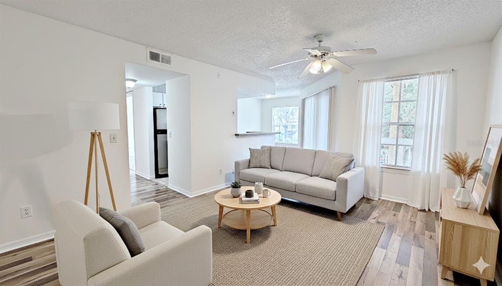 1037 South Hiawassee Road, Unit 2825 Orlando, FL 32835 - Photo 2 of 16 a living room with furniture and a chandelier