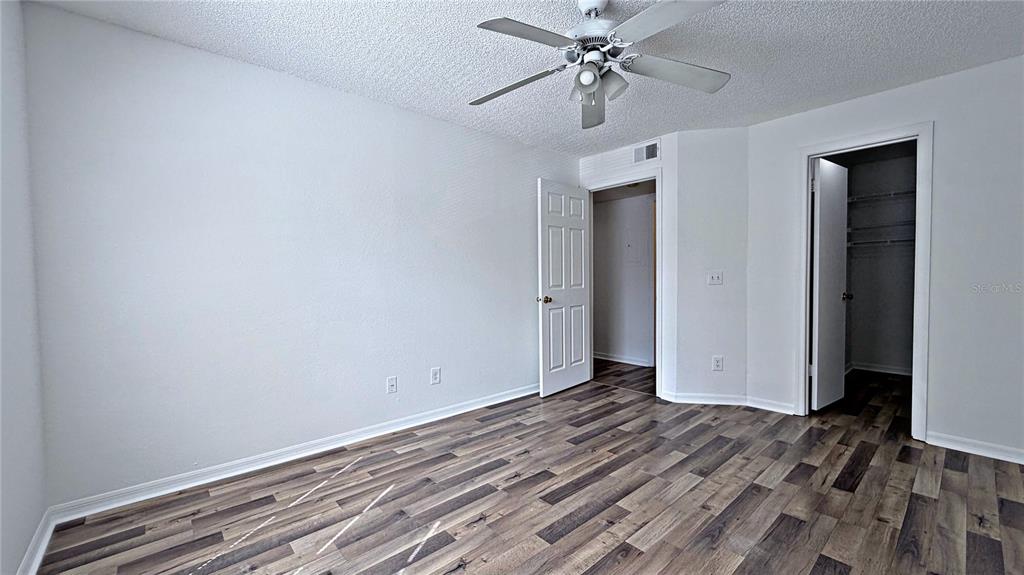 1037 South Hiawassee Road, Unit 2825 Orlando, FL 32835 - Photo 7 of 16 a view of room with hardwood floor and ceiling fan
