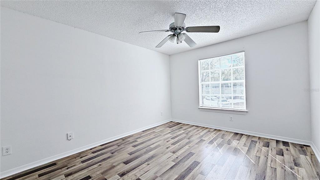 1037 South Hiawassee Road, Unit 2825 Orlando, FL 32835 - Photo 9 of 16 a view of a room with wooden floor and windows