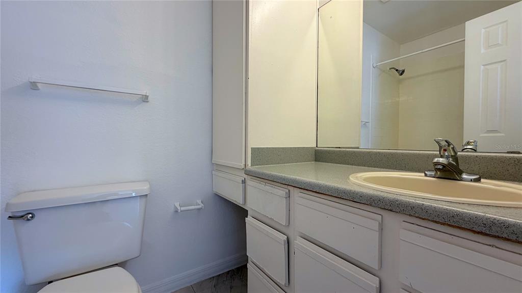 1037 South Hiawassee Road, Unit 2825 Orlando, FL 32835 - Photo 10 of 16 a bathroom with a toilet sink and mirror