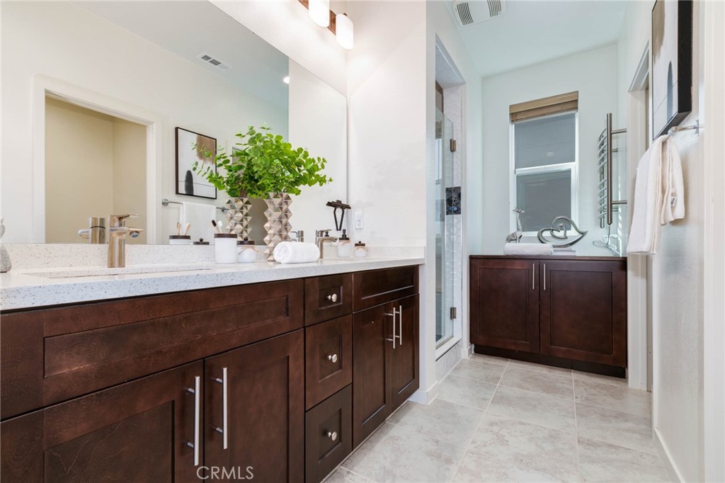 580 Cultivate Irvine, CA 92618 - Photo 13 of 30 a bathroom with a double vanity sink and a mirror