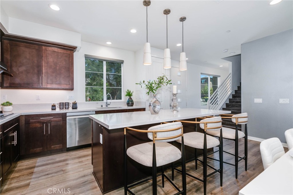 580 Cultivate Irvine, CA 92618 - Photo 6 of 30 a kitchen with stainless steel appliances granite countertop a kitchen island a stove a table and chairs in it