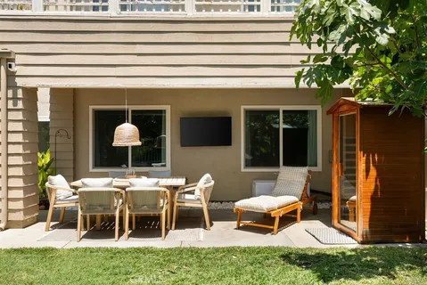 a view of a house with a backyard and sitting area