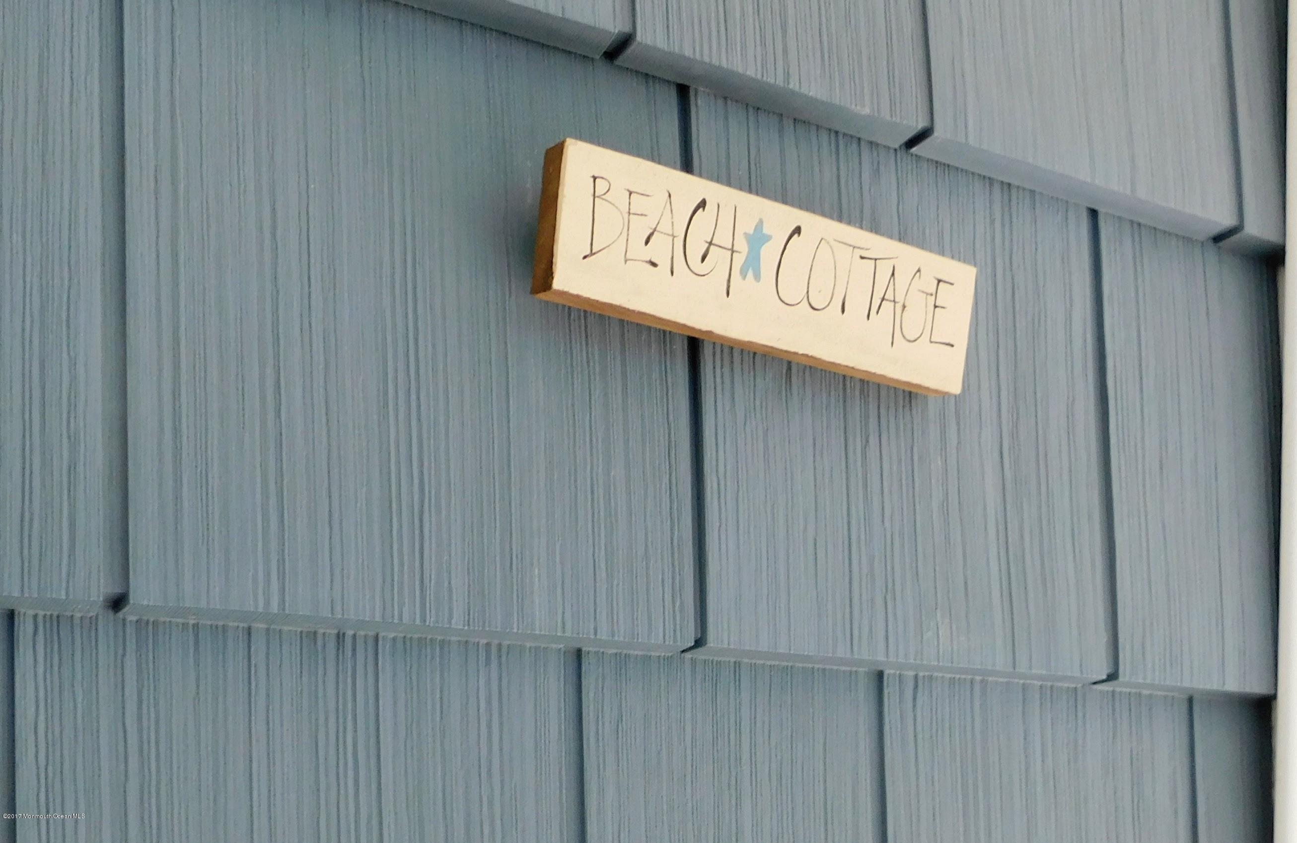 64 Manito Road Manasquan, NJ 08736 - Photo 5 of 26 a street sign sitting on a wooden wall