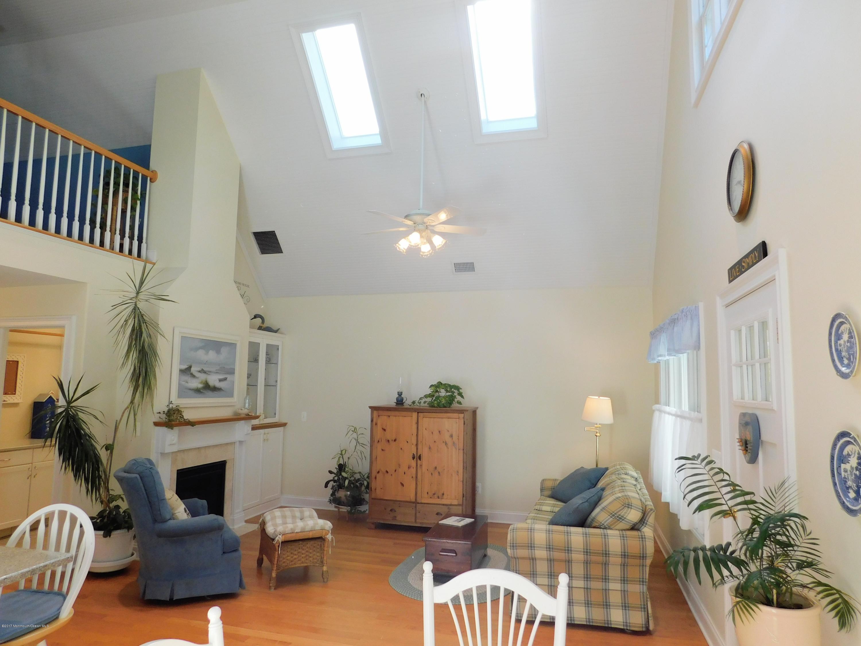 64 Manito Road Manasquan, NJ 08736 - Photo 7 of 26 a living room with furniture a rug and a fireplace