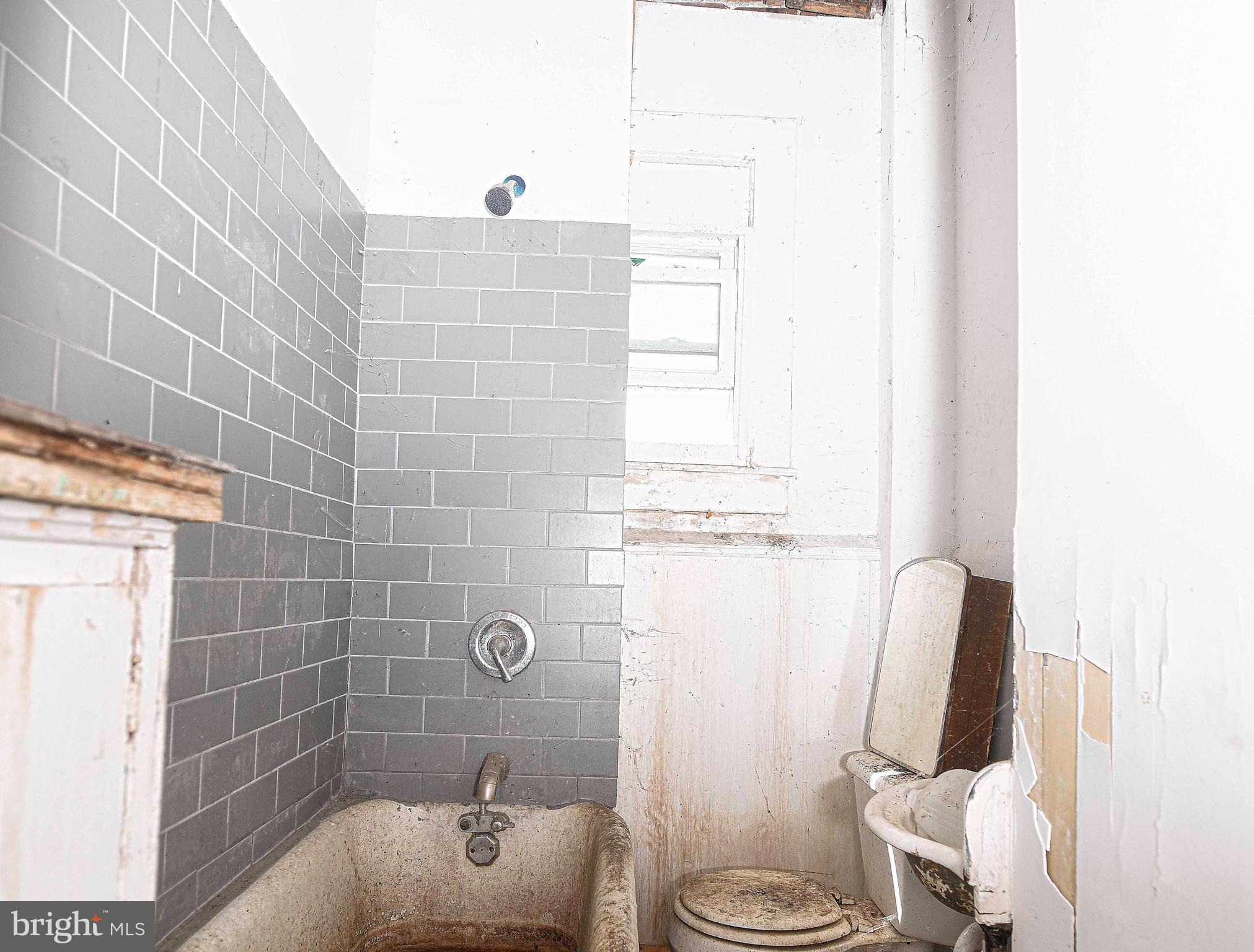 2331 Federal Street Baltimore, MD 21213 - Photo 8 of 15 a bathroom with a sink a toilet and shower