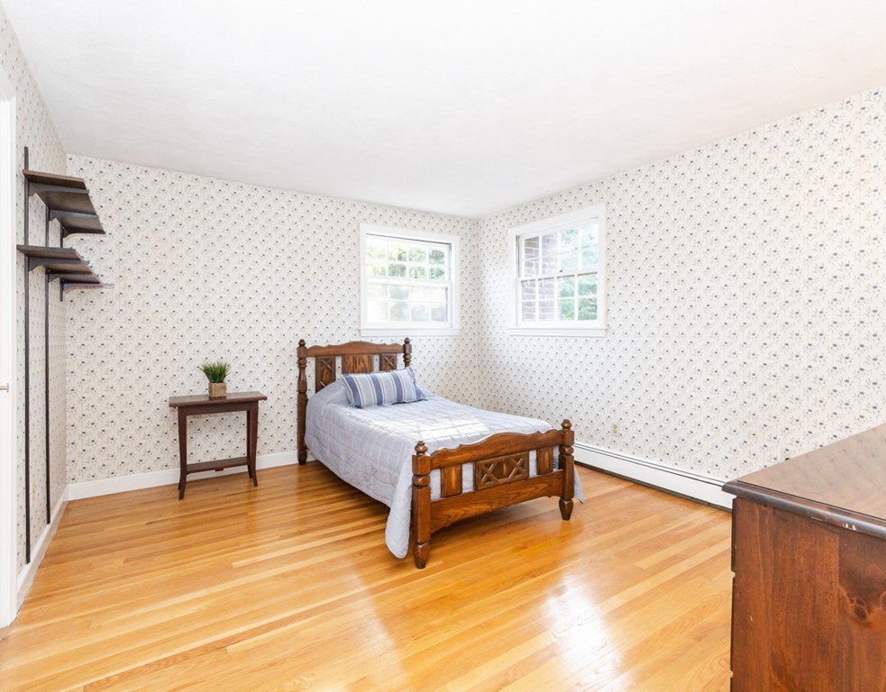 6 Goffe Road Lexington, MA 02421 - Photo 23 of 30 a bedroom with a bed and a table in it