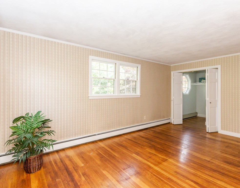 6 Goffe Road Lexington, MA 02421 - Photo 24 of 30 an empty room with wooden floor and windows