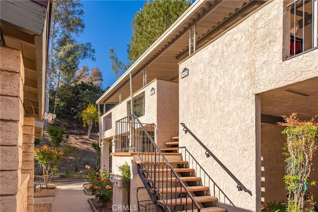 a view of a balcony with wooden floor and fence