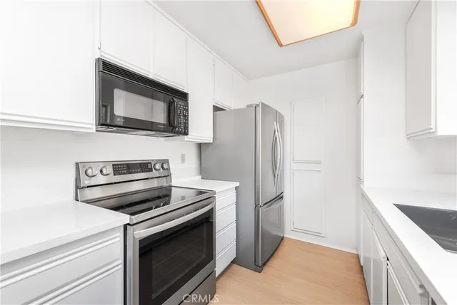 a kitchen with a refrigerator stove and microwave