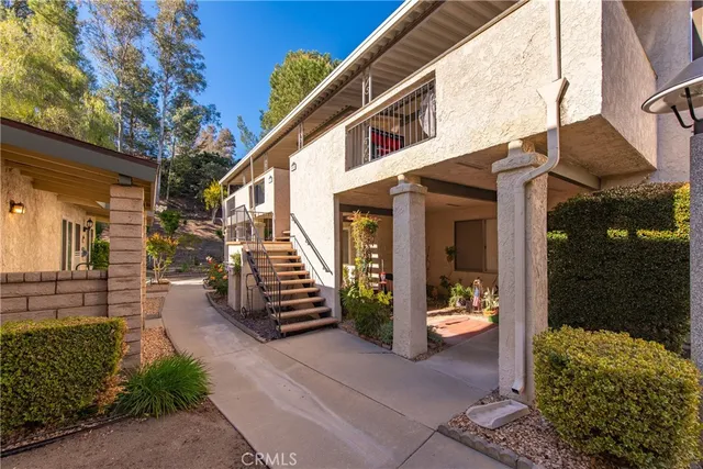a view of a house with entrance door and balcony