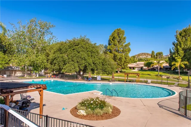 a view of a swimming pool and trees in the background