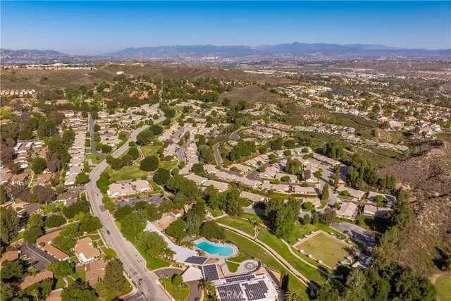 an aerial view of residential houses with city view
