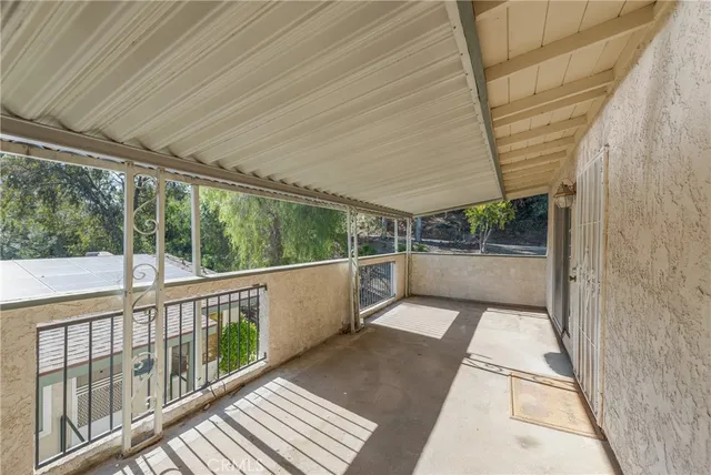a view of a balcony with wooden floor