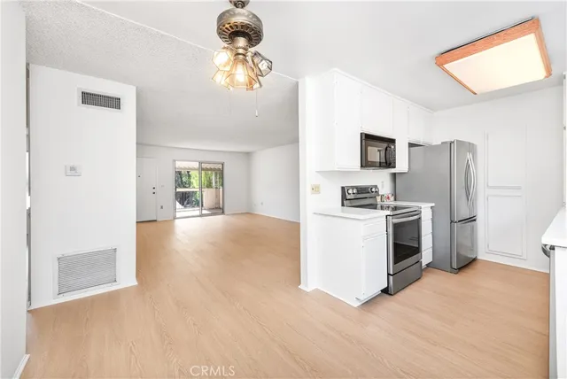 a kitchen with stainless steel appliances a refrigerator sink and stove