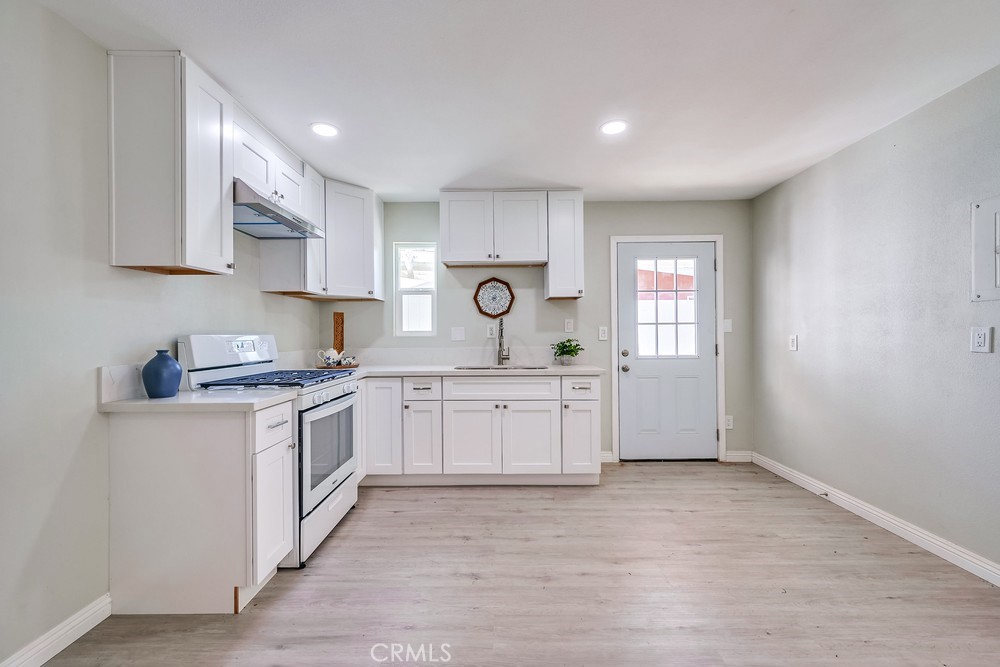 5510 Bushnell Avenue Riverside, CA 92505 - Photo 15 of 23 a kitchen with granite countertop white cabinets and white appliances