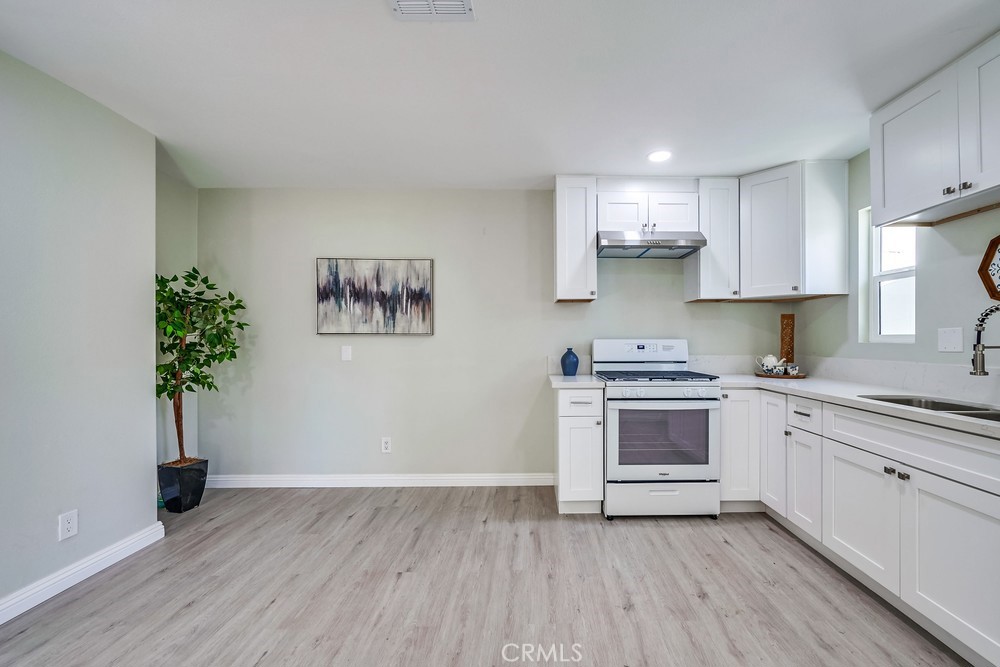 5510 Bushnell Avenue Riverside, CA 92505 - Photo 17 of 23 a kitchen with granite countertop a stove a sink and a refrigerator