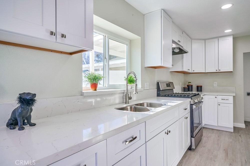 5510 Bushnell Avenue Riverside, CA 92505 - Photo 4 of 23 a kitchen with white cabinets and white appliances