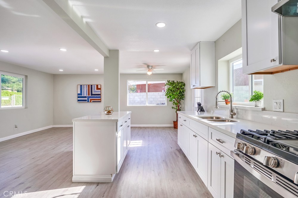 5510 Bushnell Avenue Riverside, CA 92505 - Photo 5 of 23 a kitchen with stainless steel appliances a stove a sink a refrigerator and wooden floor