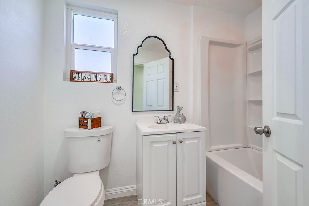 5510 Bushnell Avenue Riverside, CA 92505 - Photo 9 of 23 a bathroom with a toilet sink and mirror