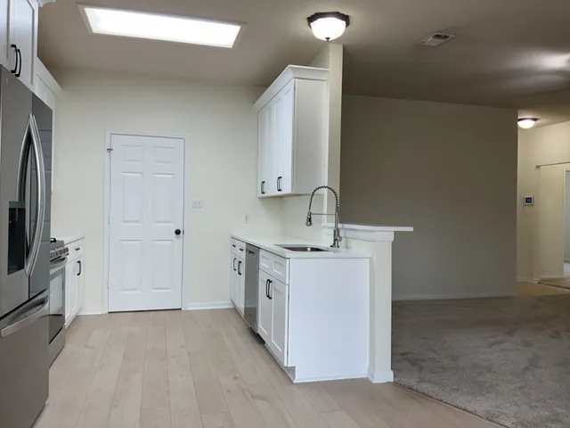 a view of a storage & utility room with a sink