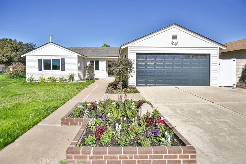 6401 Royal Oak Drive Huntington Beach, CA 92647 - Photo 1 of 49 a front view of a house with a yard and garage
