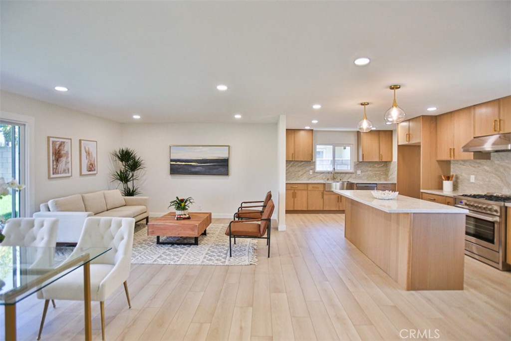 6401 Royal Oak Drive Huntington Beach, CA 92647 - Photo 15 of 49 a living room with stainless steel appliances kitchen island granite countertop furniture wooden floor and a kitchen view