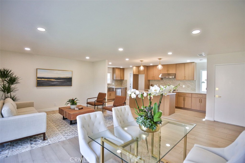 6401 Royal Oak Drive Huntington Beach, CA 92647 - Photo 16 of 49 a living room with kitchen island furniture and a view of kitchen