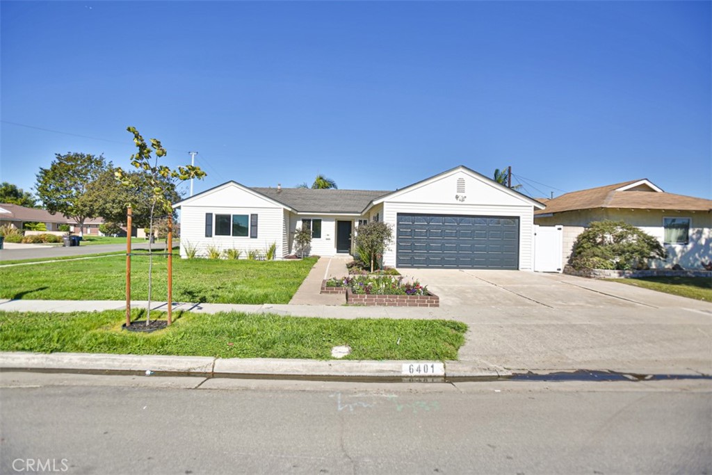 6401 Royal Oak Drive Huntington Beach, CA 92647 - Photo 2 of 49 a front view of a house with a yard and garage
