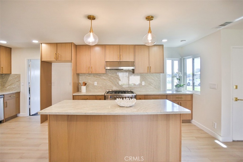 6401 Royal Oak Drive Huntington Beach, CA 92647 - Photo 28 of 49 a kitchen with stainless steel appliances granite countertop a sink refrigerator and cabinets