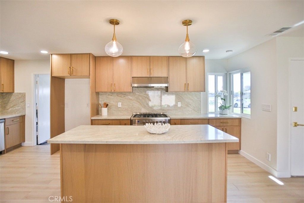 6401 Royal Oak Drive Huntington Beach, CA 92647 - Photo 29 of 49 a kitchen with stainless steel appliances granite countertop a sink refrigerator and cabinets