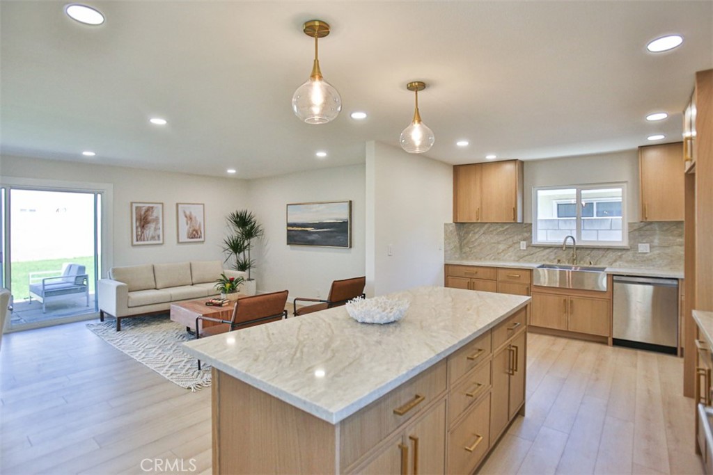 6401 Royal Oak Drive Huntington Beach, CA 92647 - Photo 31 of 49 a kitchen with stainless steel appliances granite countertop a kitchen island a stove and a sink