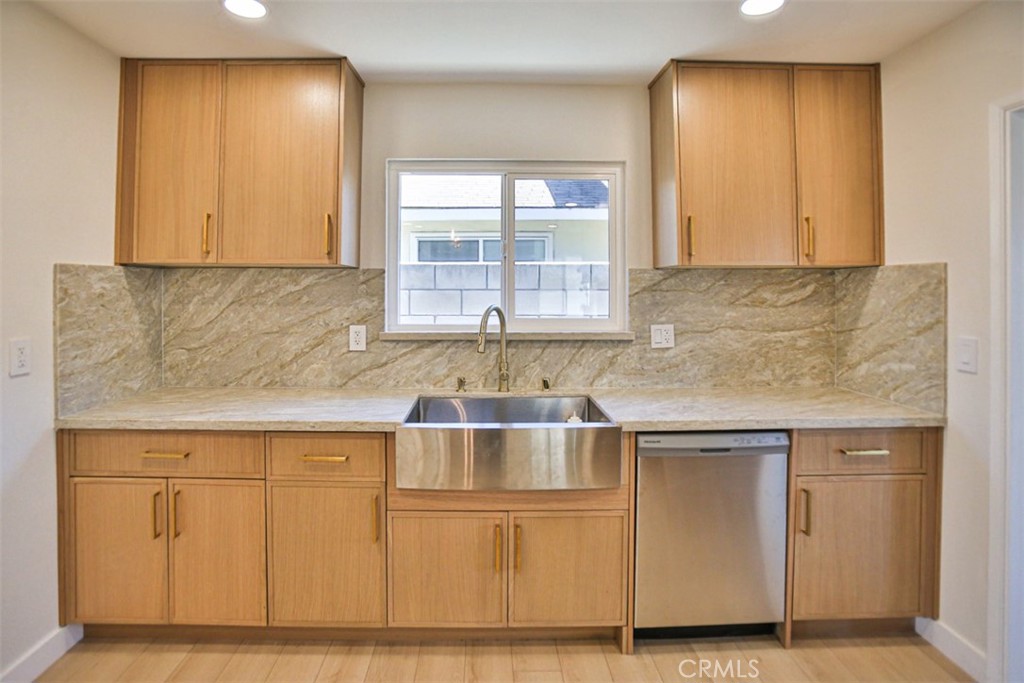 6401 Royal Oak Drive Huntington Beach, CA 92647 - Photo 33 of 49 a kitchen with white cabinets and a sink