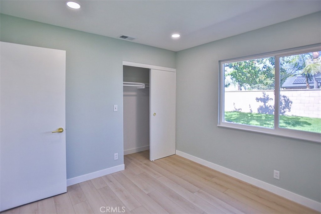 6401 Royal Oak Drive Huntington Beach, CA 92647 - Photo 37 of 49 an empty room with wooden floor and windows