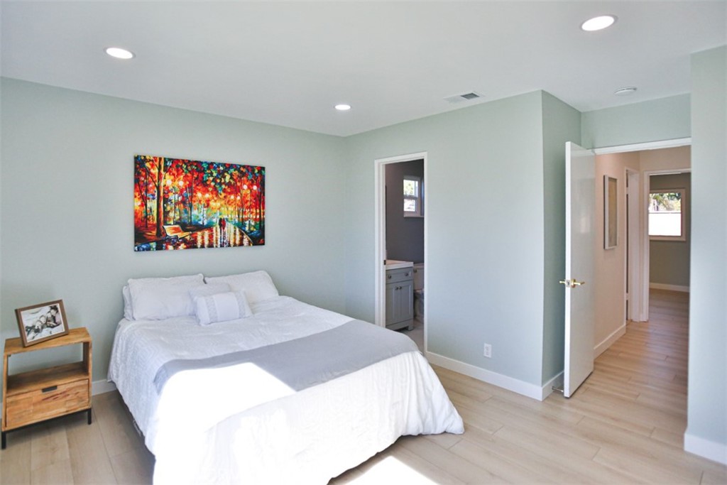 6401 Royal Oak Drive Huntington Beach, CA 92647 - Photo 41 of 49 a bedroom with a bed and a painting on the wall