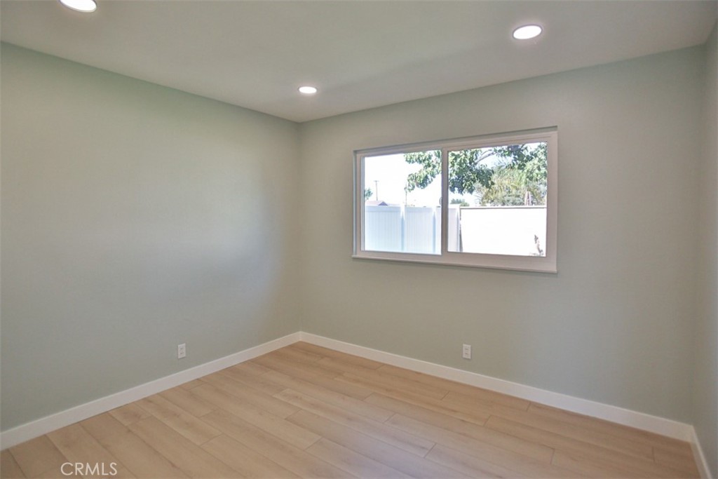 6401 Royal Oak Drive Huntington Beach, CA 92647 - Photo 47 of 49 an empty room with wooden floor and windows