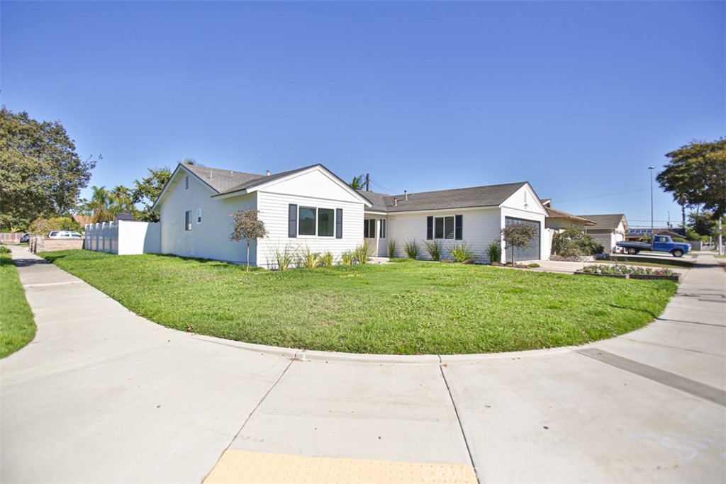 6401 Royal Oak Drive Huntington Beach, CA 92647 - Photo 5 of 49 a front view of a house with a garden and plants