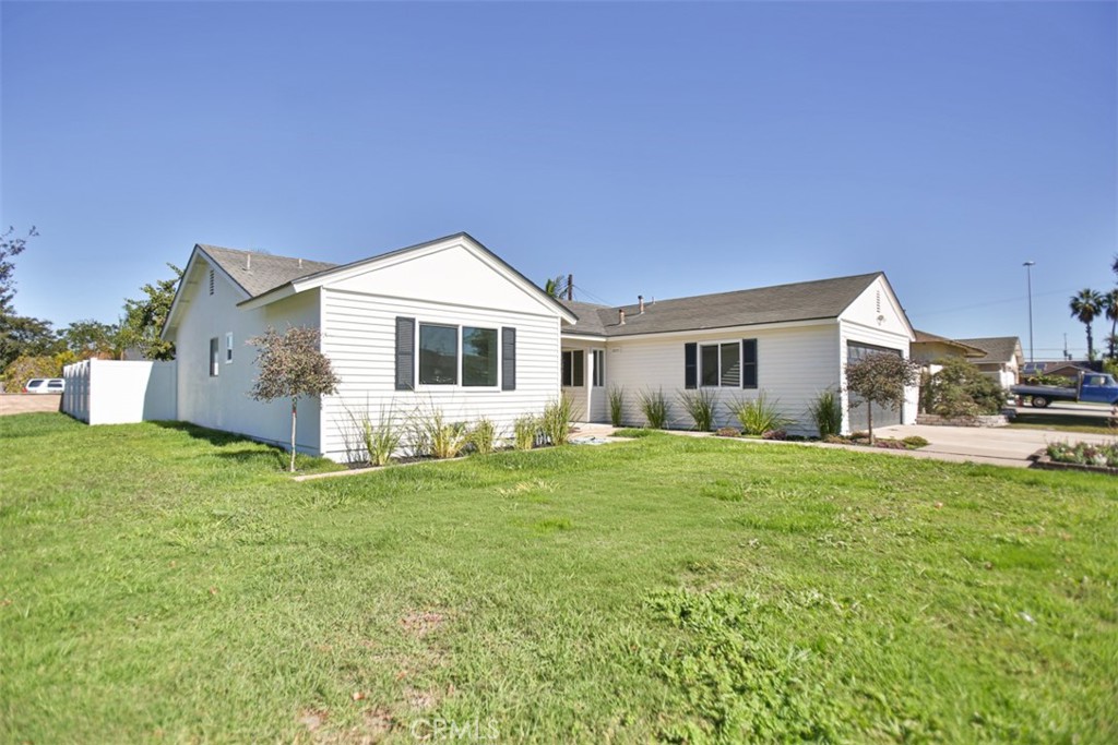 6401 Royal Oak Drive Huntington Beach, CA 92647 - Photo 7 of 49 a front view of a house with a garden