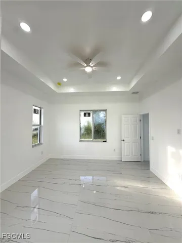 a large kitchen with kitchen island a sink wooden floor and a counter top space