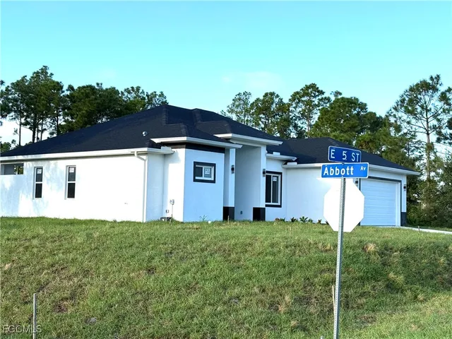 a house that has a tree in front of it